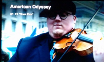 Screencap of street violinist in American Odyssey